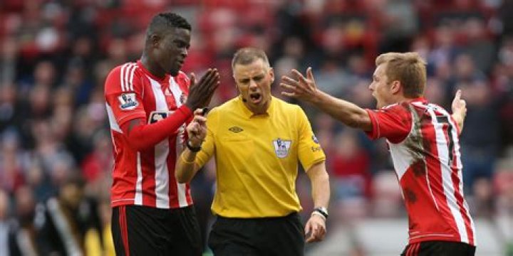 Can a player touch a referee in football?