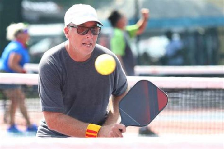 Can a player touch the net in pickleball?