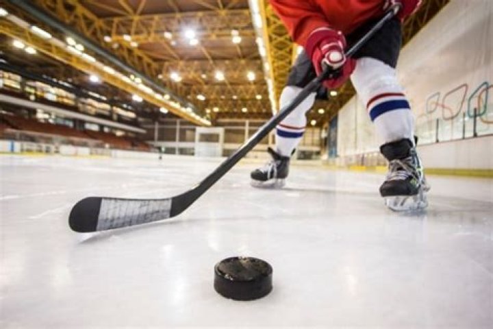 Can you pick up the puck with your stick in hockey?