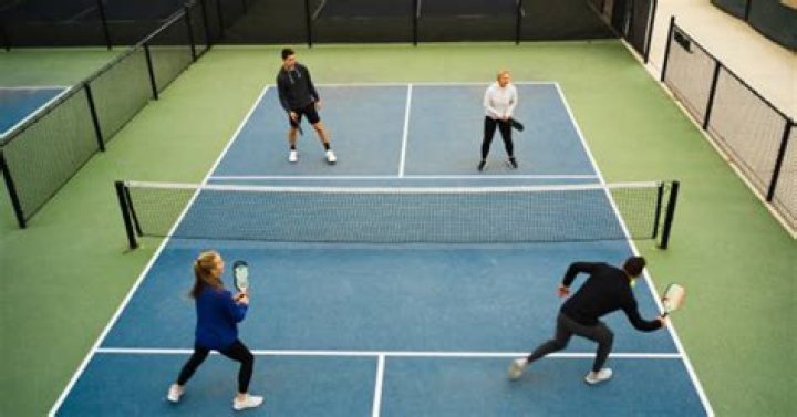 Can you stand in the kitchen and spike the ball in pickleball?