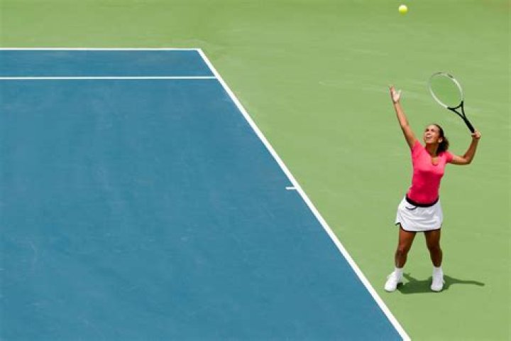 Can your foot touch the line when serving in tennis?