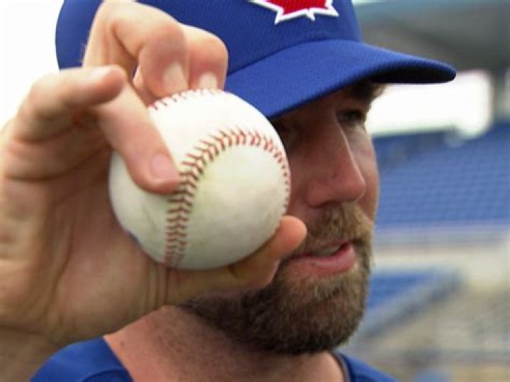 How does R.A. Dickey throw his knuckleball?