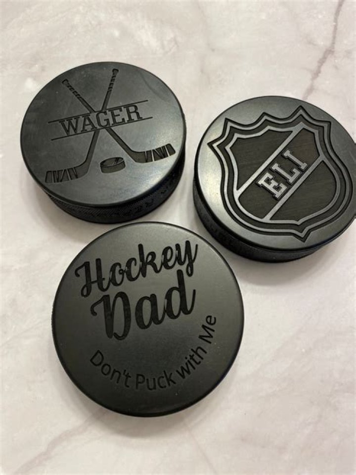 What was pucks made of before rubber?