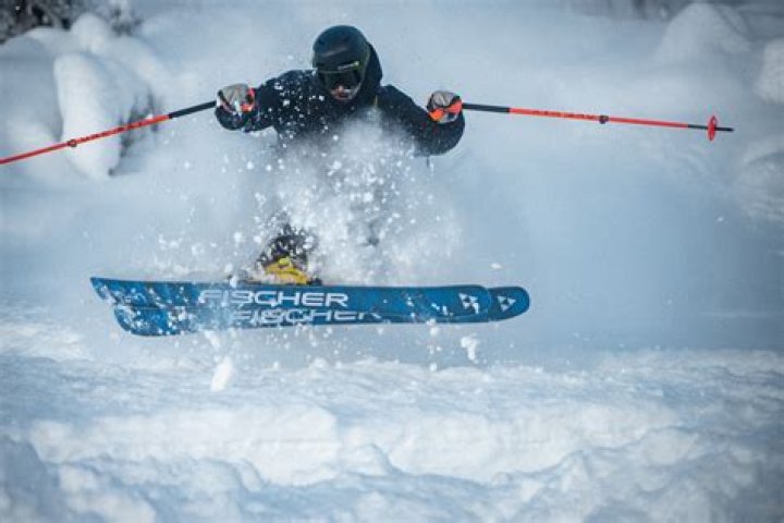 Why do freestyle skiers put their arms up?