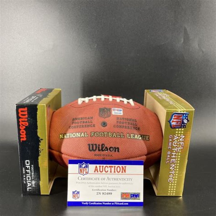 Why do quarterbacks pat the ball before throwing?