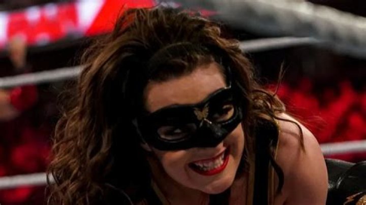 Why does Nikki A.S.H. wear a mask?